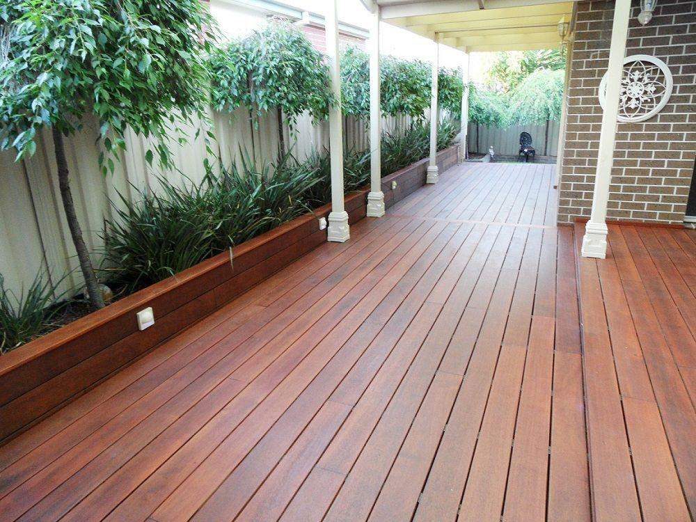 Kwila deck running the length of a covered verandah with a planter edge