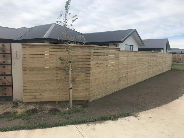 Horizontal timber slat boundary fence beside new Christchurch homes