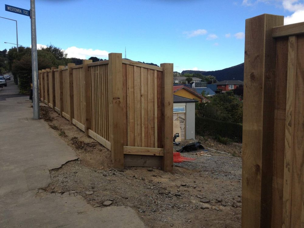 Timber batten fence stepping down a sloping Port Hills street boundary