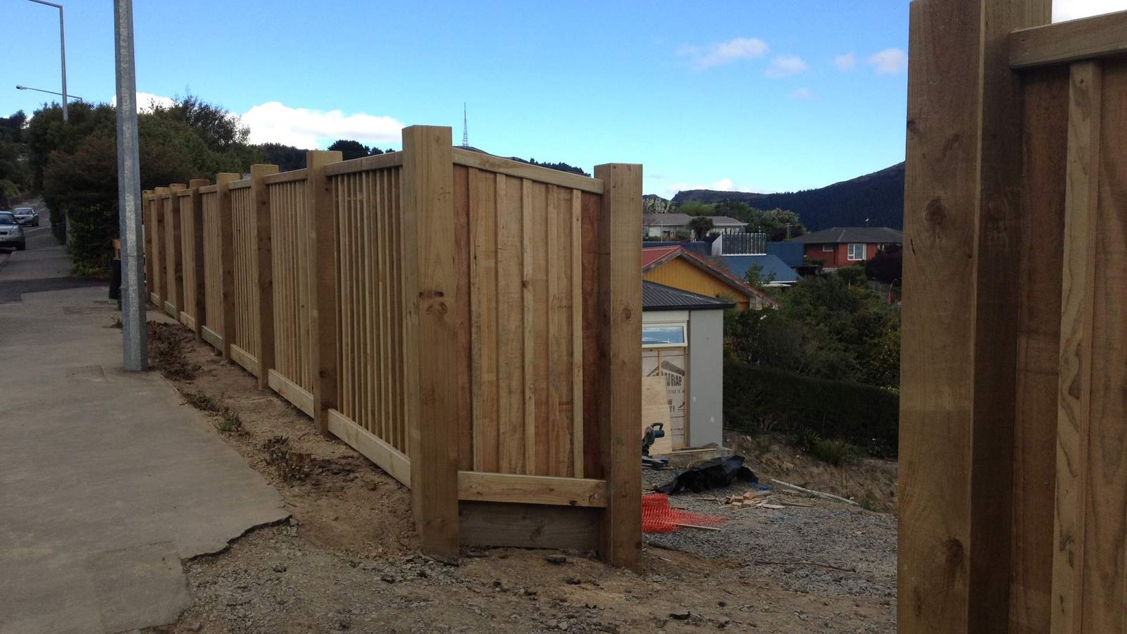 Tall timber paling fence running along a Christchurch street boundary