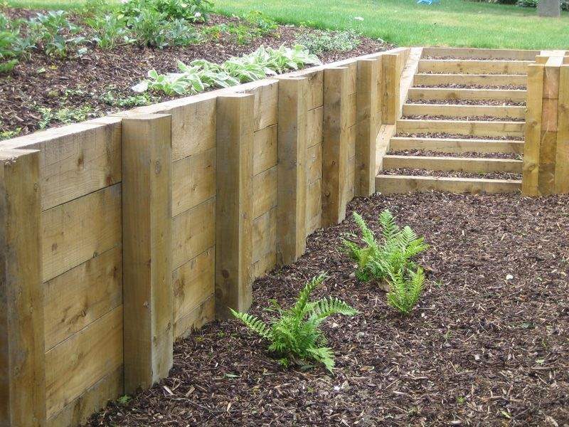 Timber retaining wall with a flight of timber steps built through it